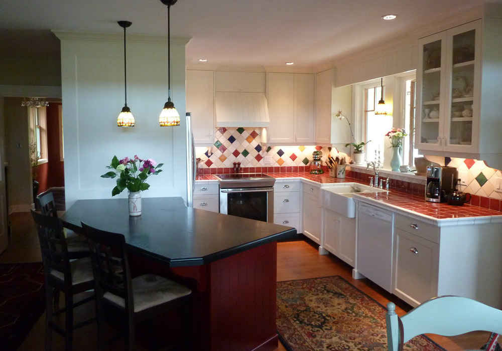 Bright kitchen with painted face-frame cabinets, colourful tile backsplash and island
