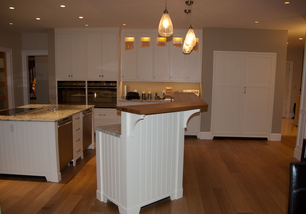 Floor-to-ceiling frameless cabinetry in dark finish