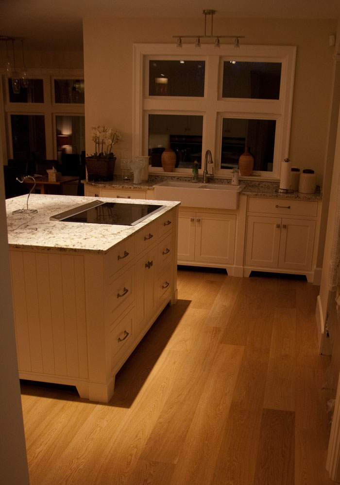 Kitchen island with granite countertop at evening, warm lighting