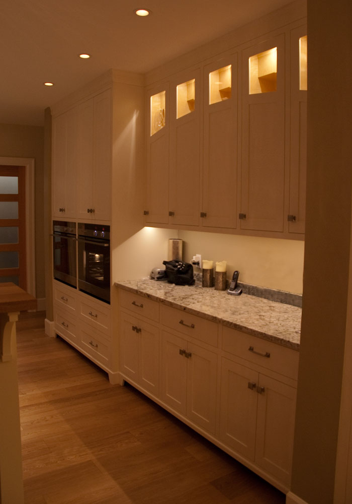 Full-height wall of cabinetry with integrated lit display niches
