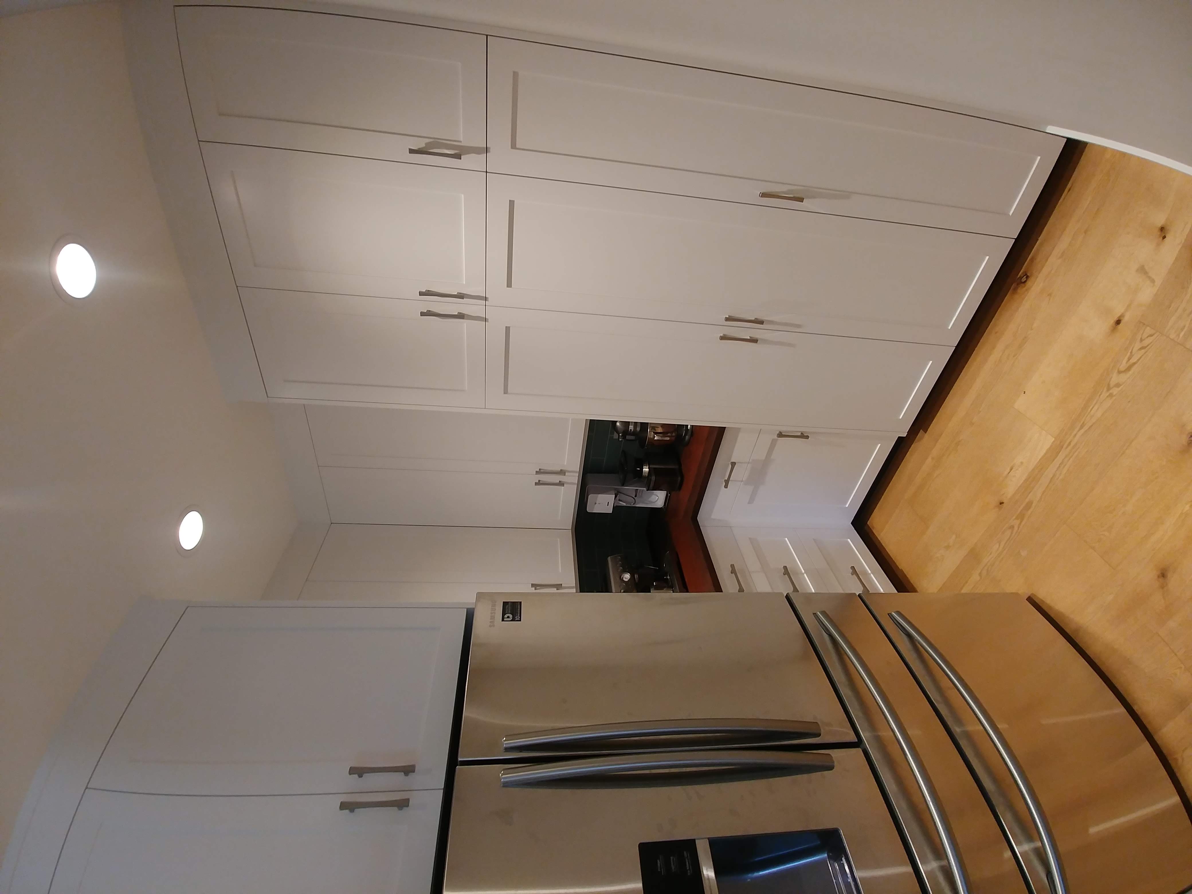 Floor-to-ceiling frameless cabinetry in a pantry nook.