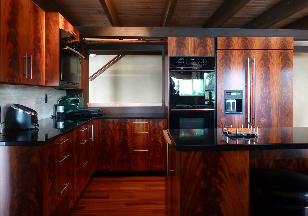 Crotch mahogany cabinetry with integrated appliances