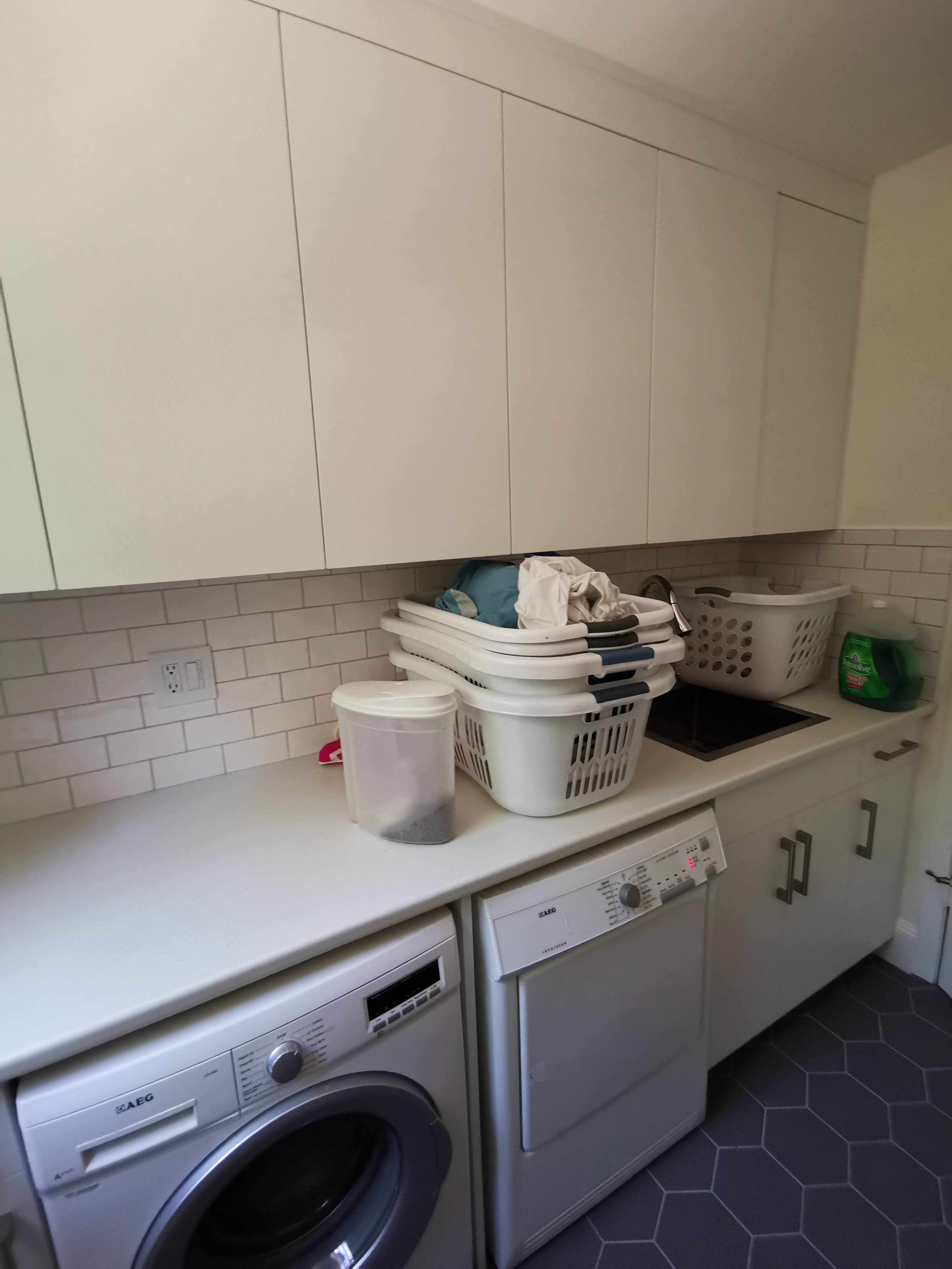 Matte slab doors in laundry room cabinetry