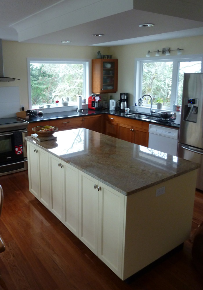 Kitchen island and perimeter cabinetry showing mixed cherry and painted finish